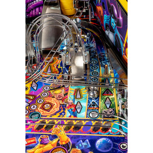 Close-up of a colorful pinball machine playfield with metallic rails, comic-style artwork, and character graphics including Thor, Spider-Man, and others.